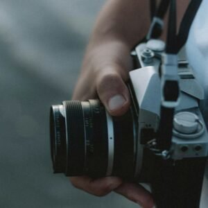 person holding black and silver dslr camera